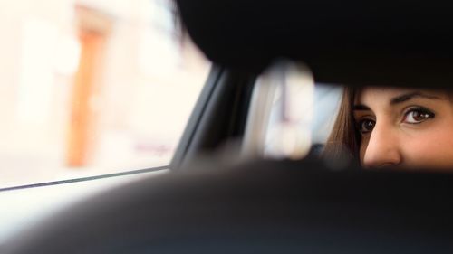Close-up portrait of woman in car