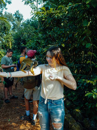 People standing against plants