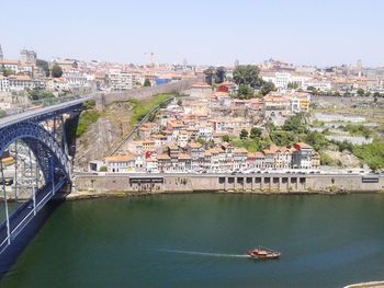 Boats in river with city in background