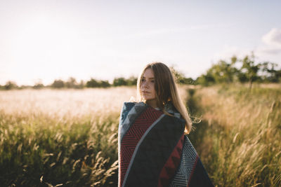 Woman standing on grassy field