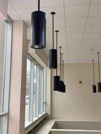Low angle view of illuminated pendant lights hanging from ceiling