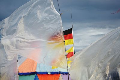 Multi colored flag against sky