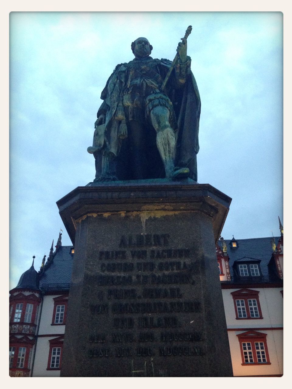 transfer print, statue, human representation, sculpture, building exterior, auto post production filter, low angle view, architecture, art and craft, built structure, art, creativity, sky, blue, no people, outdoors, day, history