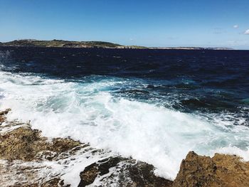 Scenic view of sea against clear blue sky