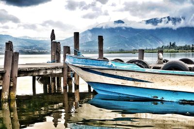 Panoramic view of boats moored in lake against sky