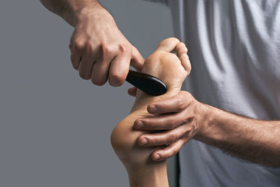 Midsection of man using mobile phone