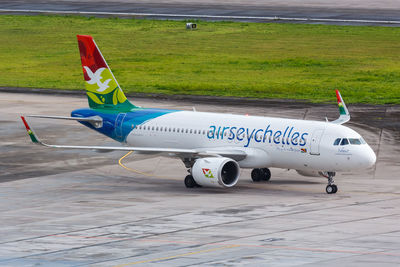 Side view of airplane on airport runway