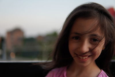 Close-up portrait of a smiling young woman