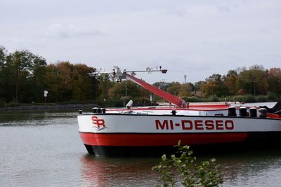 Boat in river against sky