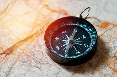 Close-up of navigational compass on cracked floor