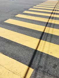 Shadow of zebra crossing on road
