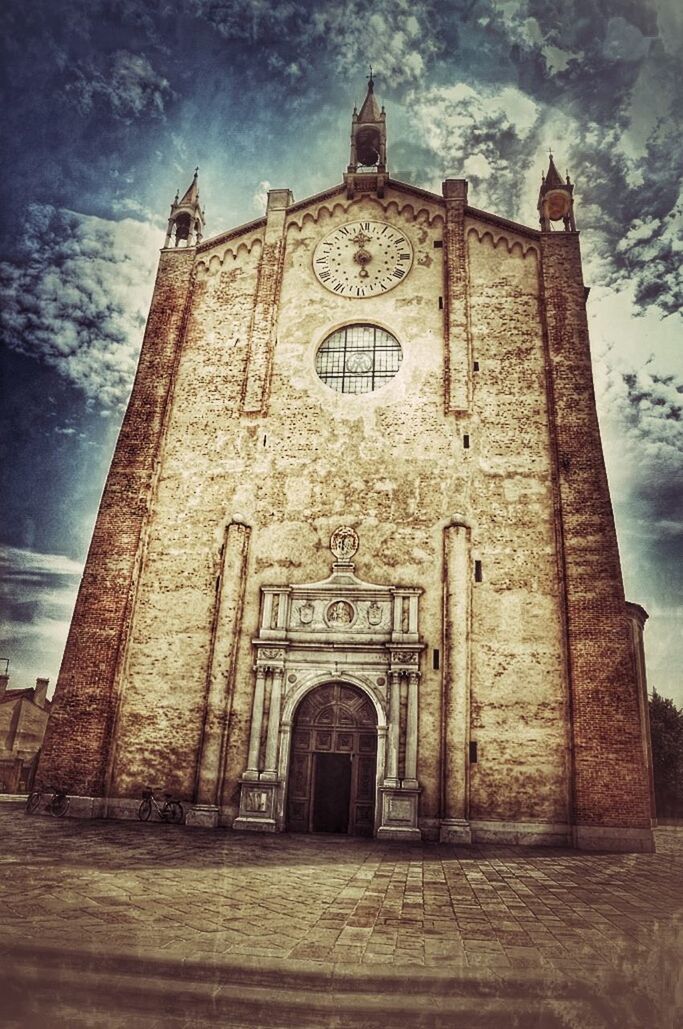 architecture, building exterior, built structure, sky, religion, low angle view, place of worship, church, spirituality, cloud - sky, old, facade, cross, history, door, outdoors, cloud, day