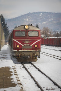 Train on railroad track against sky during winter