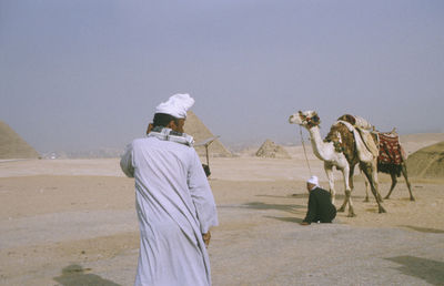 Woman on landscape against clear sky