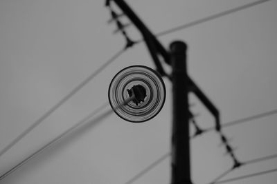 Low angle view of electricity pylon against sky