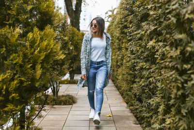 Woman walking on sidewalk