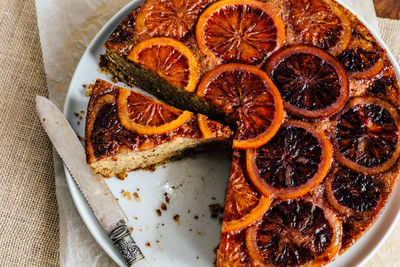 High angle view of dessert in plate on table, blood orange syrup cake