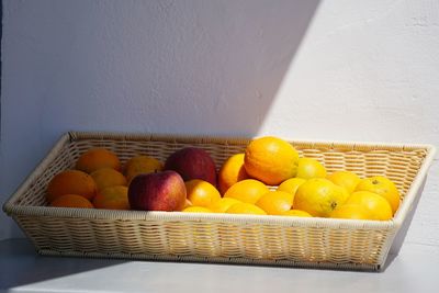 High angle view of fruits in basket against wall