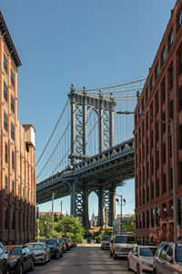 View of bridge in city against clear sky