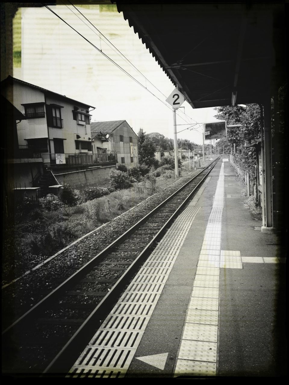 railroad track, rail transportation, transportation, built structure, architecture, transfer print, the way forward, railroad station platform, railroad station, diminishing perspective, public transportation, building exterior, vanishing point, auto post production filter, railway track, city, empty, day, sky, long