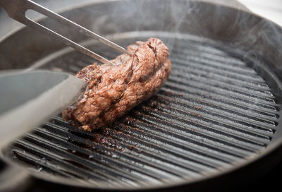 High angle view of meat on barbecue grill