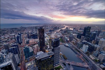 High angle view of cityscape against cloudy sky