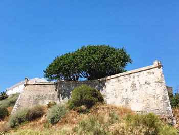 Low angle view of castle against clear blue sky