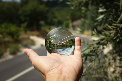 Close-up of hand holding crystal ball