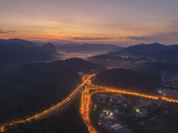 High angle view of mountains against sky at sunset