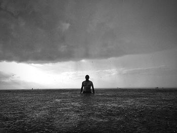 Man in sea during rainy season