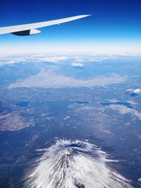 Aerial view of airplane wing over landscape