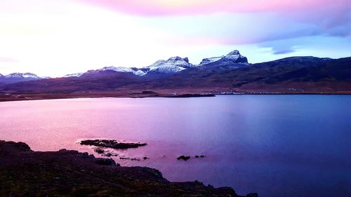 Scenic view of lake against sky at sunset