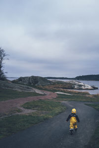 Child walking at sea