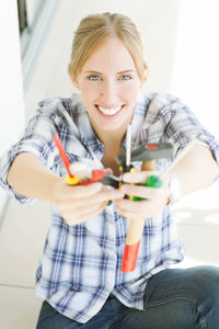 Portrait of confident female electrician working