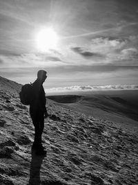 Man standing on field against sky