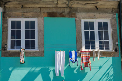 Laundry hanging from clothesline by wall