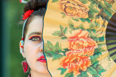 Close-up of young woman with umbrella