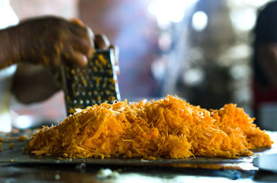 Close-up of hand holding food on table