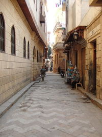 People walking on street amidst buildings in city