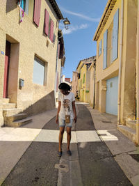 Full length of woman on narrow street in la tour d'aigues 