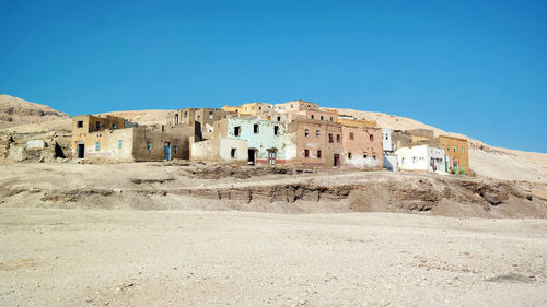 Buildings against clear blue sky