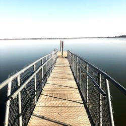 Pier over sea against clear sky