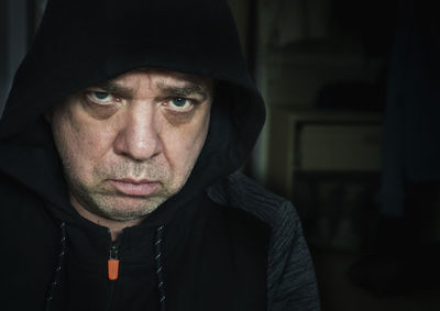 Close-up portrait of man wearing hooded shirt