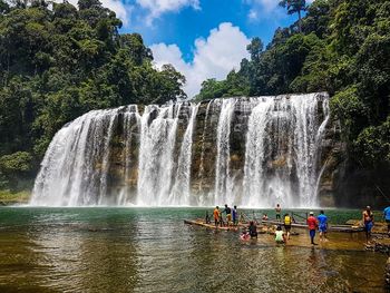 Scenic view of waterfall against trees