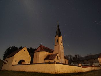 Low angle view of building against sky at night