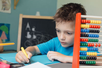 Portrait of boy doing homework