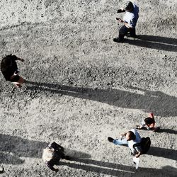 High angle view of man using mobile phone on road