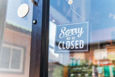 Close-up of text on glass door