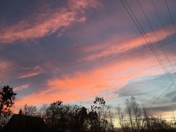 Low angle view of silhouette trees against sky during sunset