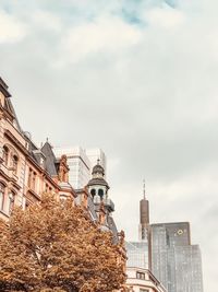 Low angle view of buildings against cloudy sky